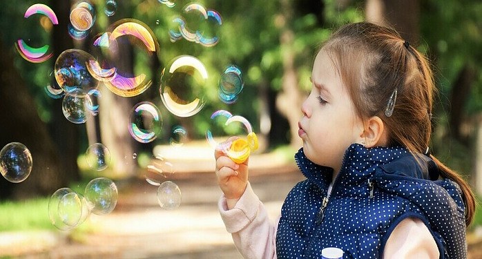 a kid playing with bubbles