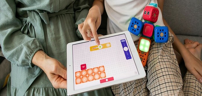 a mother and daughter playing with educational toys